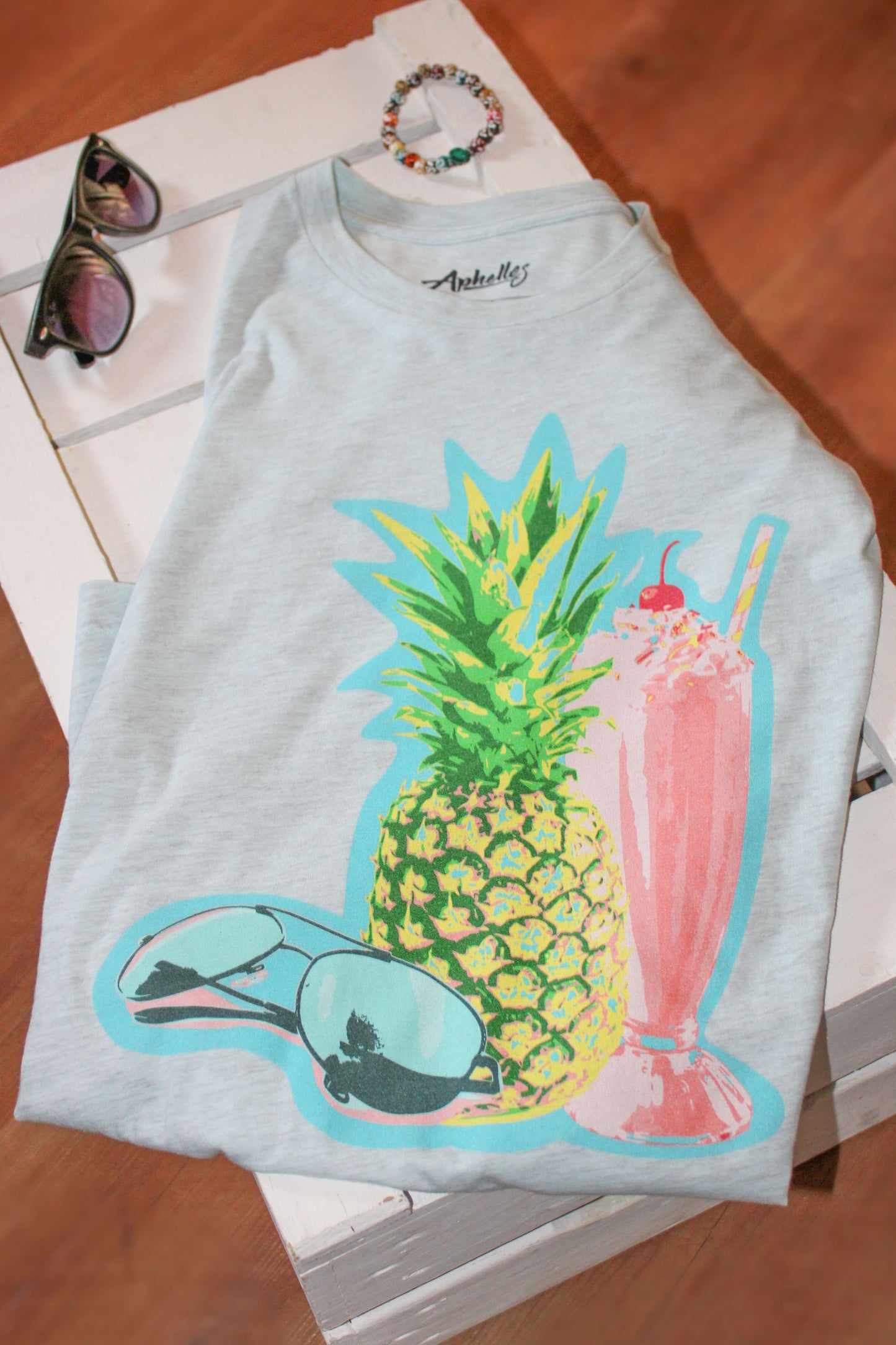 Light blue T-shirt with a juicy pineapple and icecream featured on the front