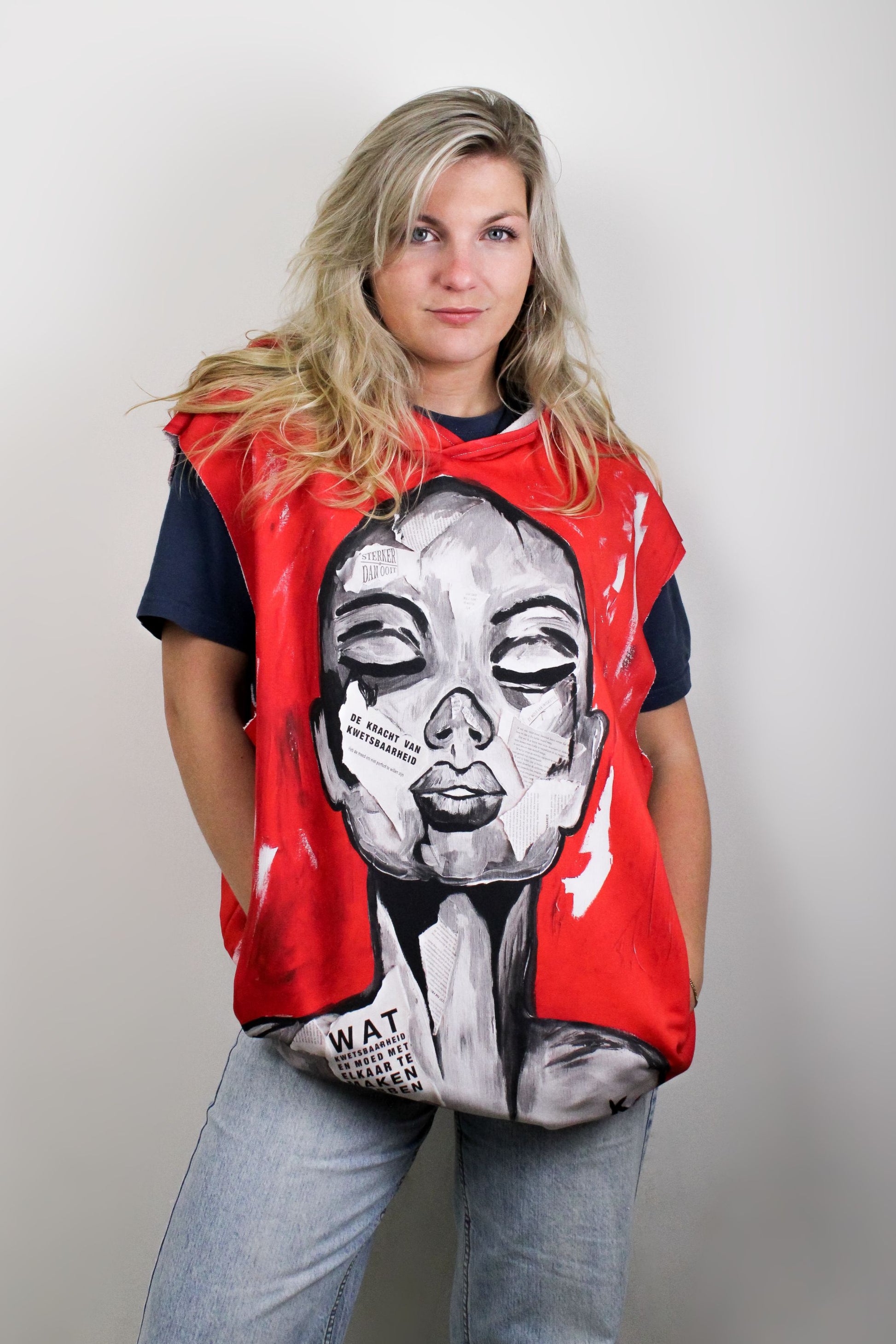 a red hoodie with the unique design of a womans face on the front