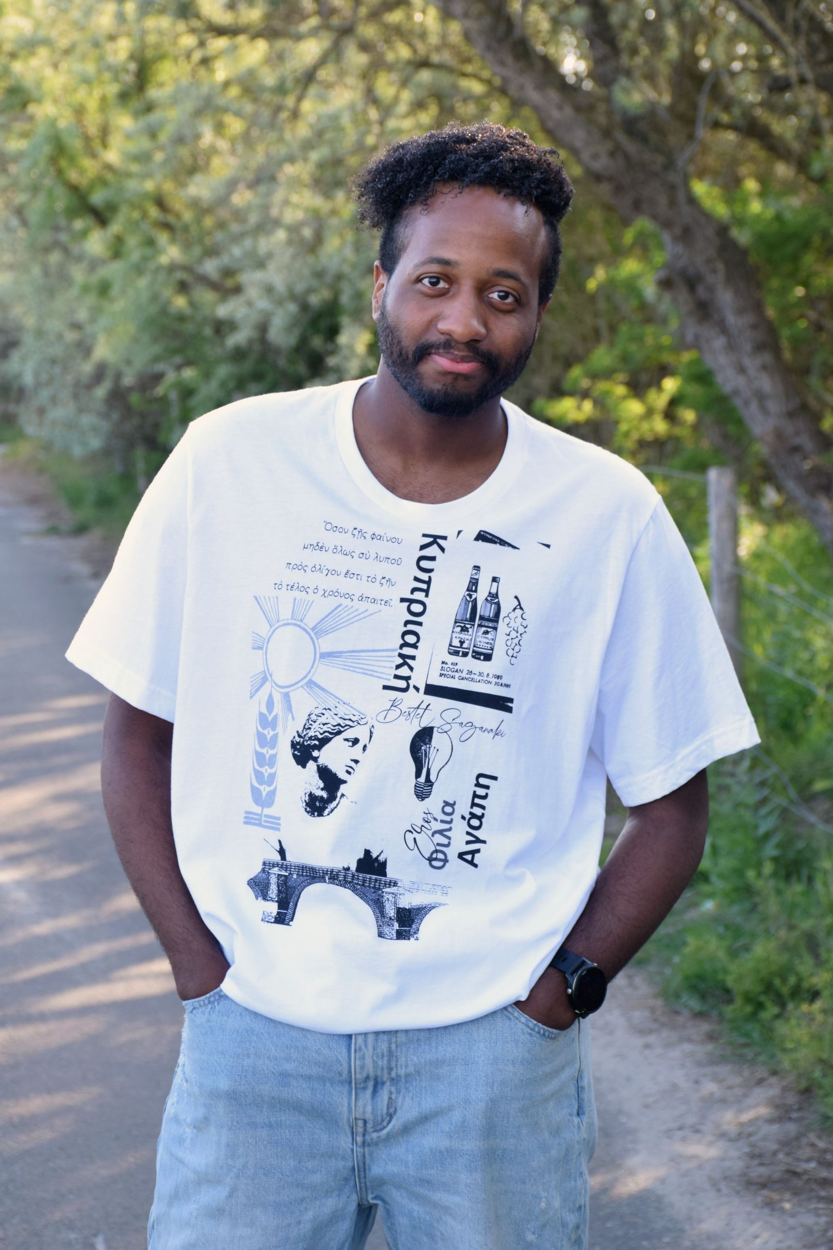 Minimalist white T-shirt with bold black ancient Greek text and mythological motif.