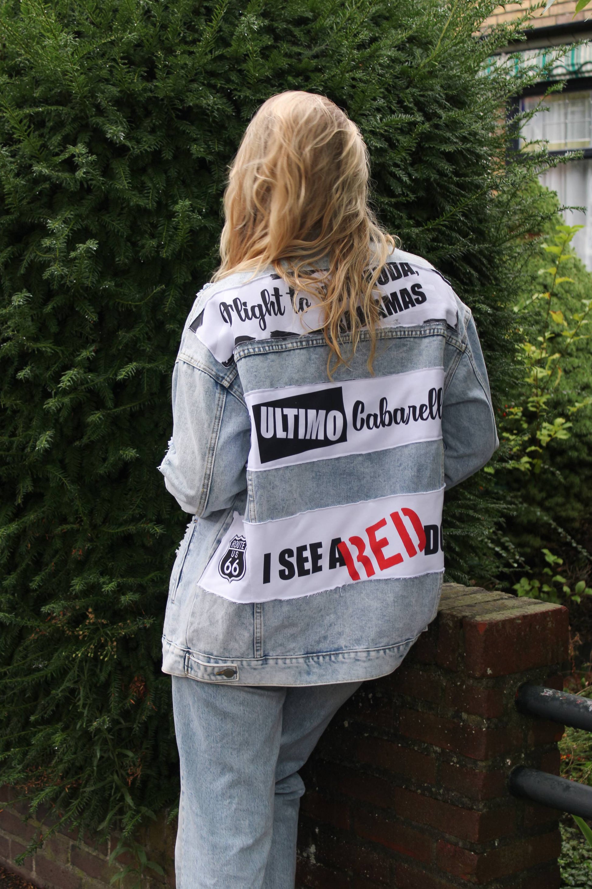 Artistic oversized light blue denim jacket with 'El Último Caballero' text and custom musical panel designs