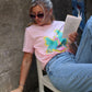 A pink salmon coloured t shirt with a vibrant tropical flamingo print design made of 100% cotton