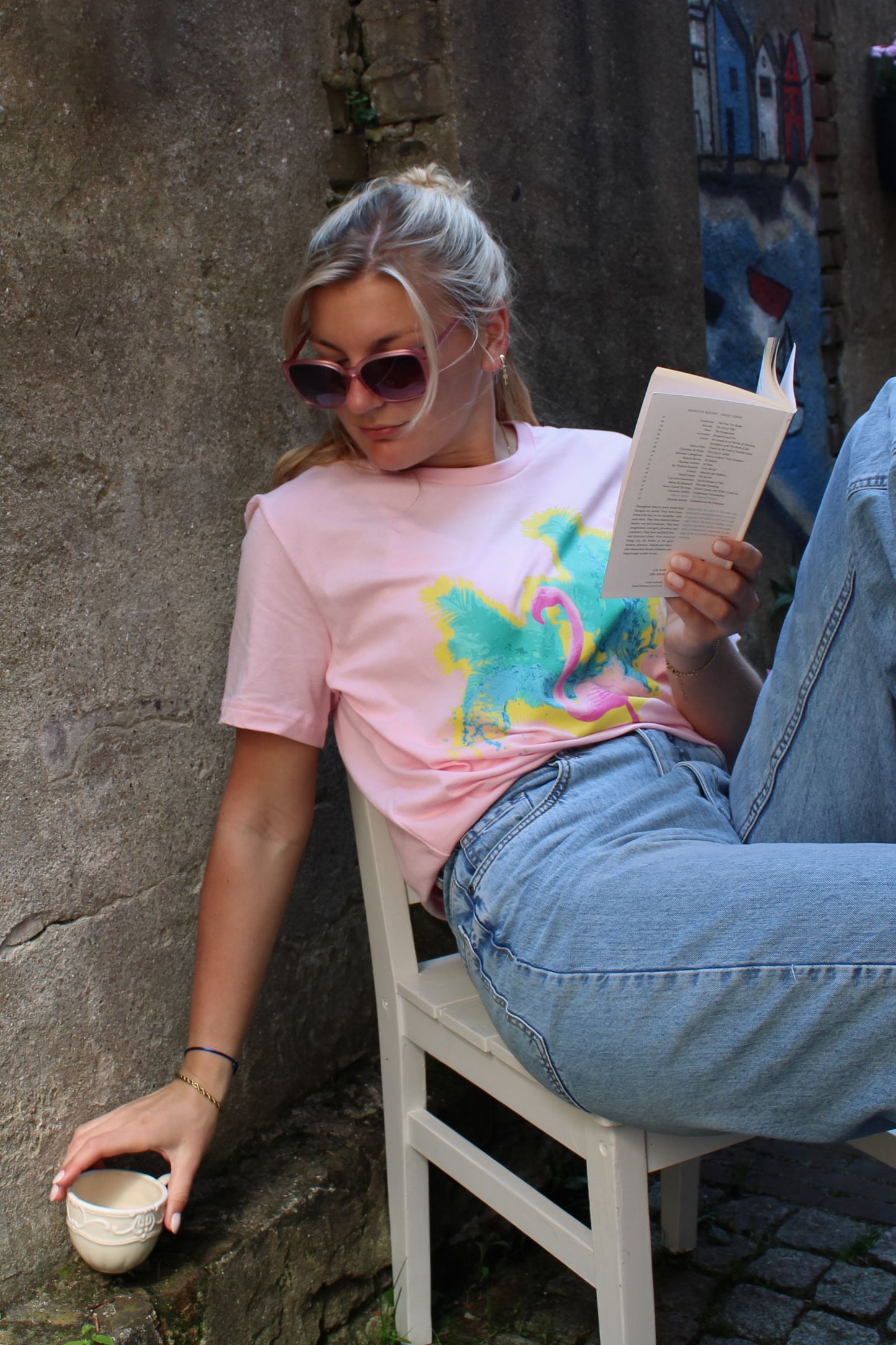 A pink salmon coloured t shirt with a vibrant tropical flamingo print design made of 100% cotton