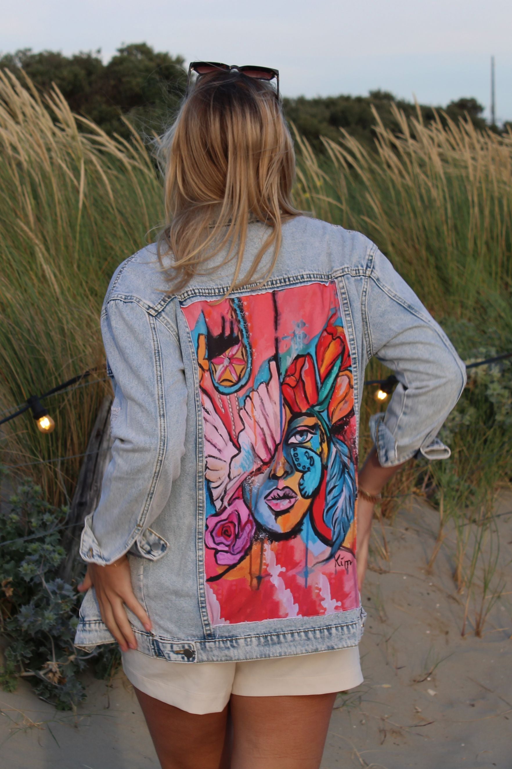 Vintage-style light blue denim jacket for women with a semi-oversized fit and unique artistic design on the back