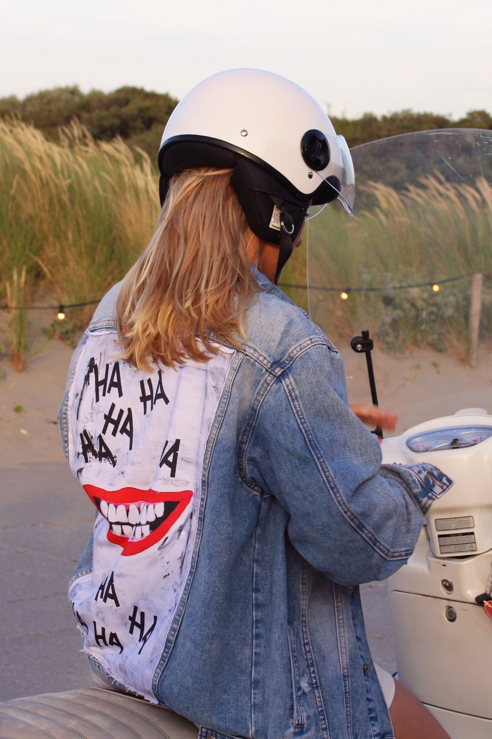 a sky blue denim jacket with smile on the back panel