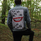 a sky blue denim jacket with smile on the back panel