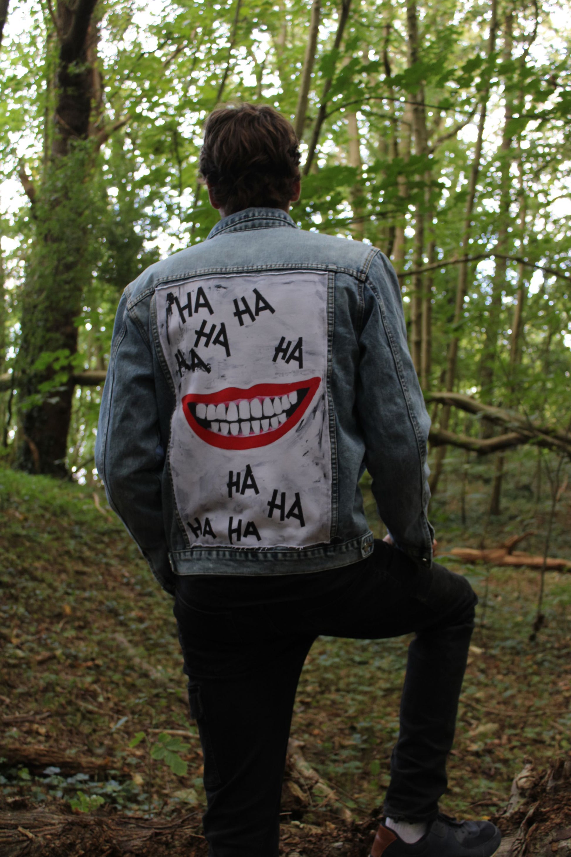 a sky blue denim jacket with smile on the back panel