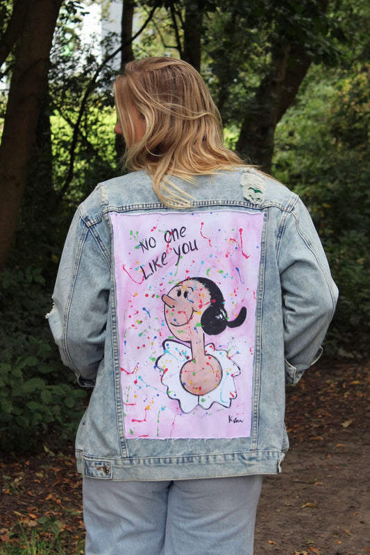 Light blue denim jacket with a colorful painting of Olive Oyl on the back against a pink background.