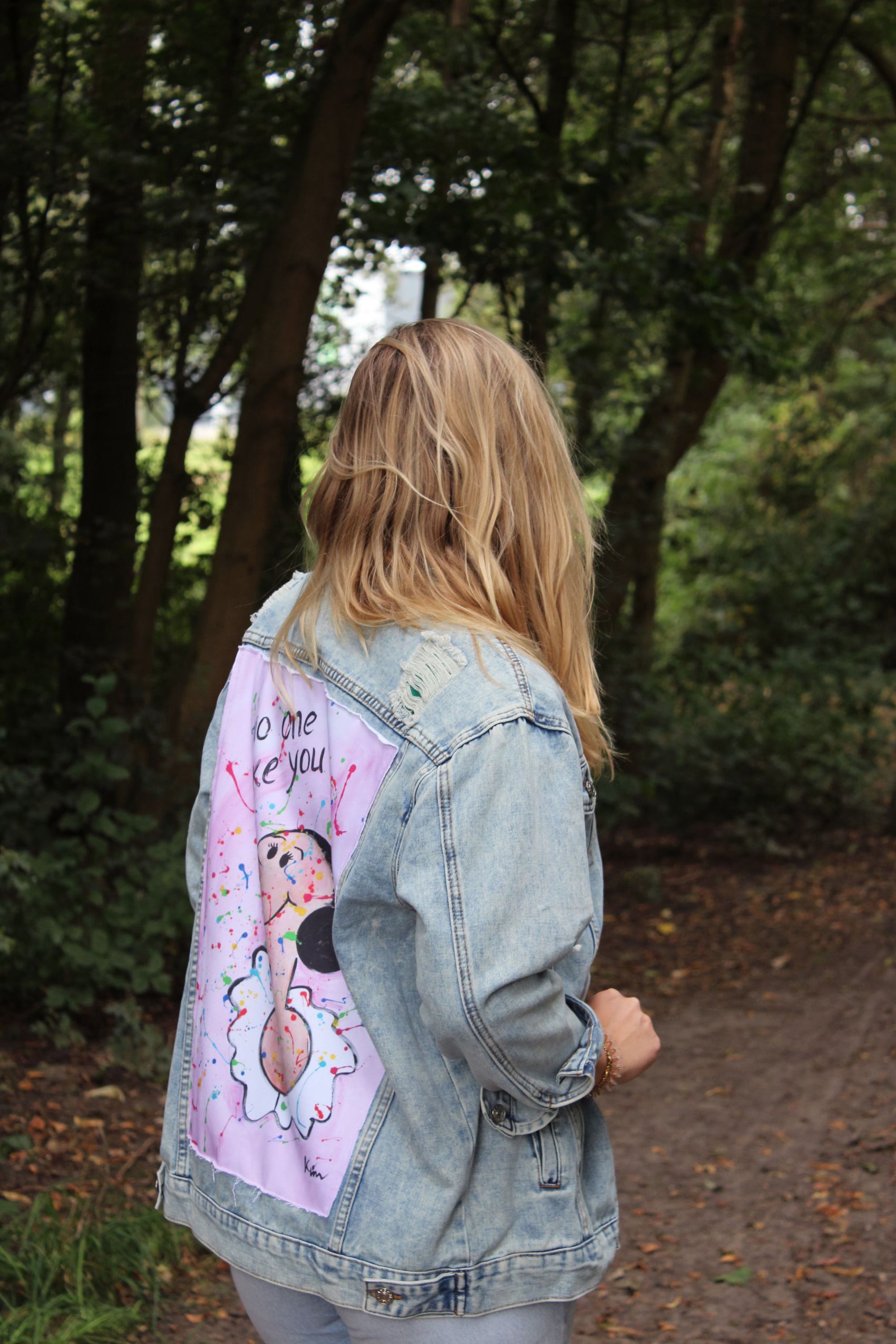 Denim jacket with a soft pink and blue color palette, showcasing Olive Oyl in a striking back panel artwork.