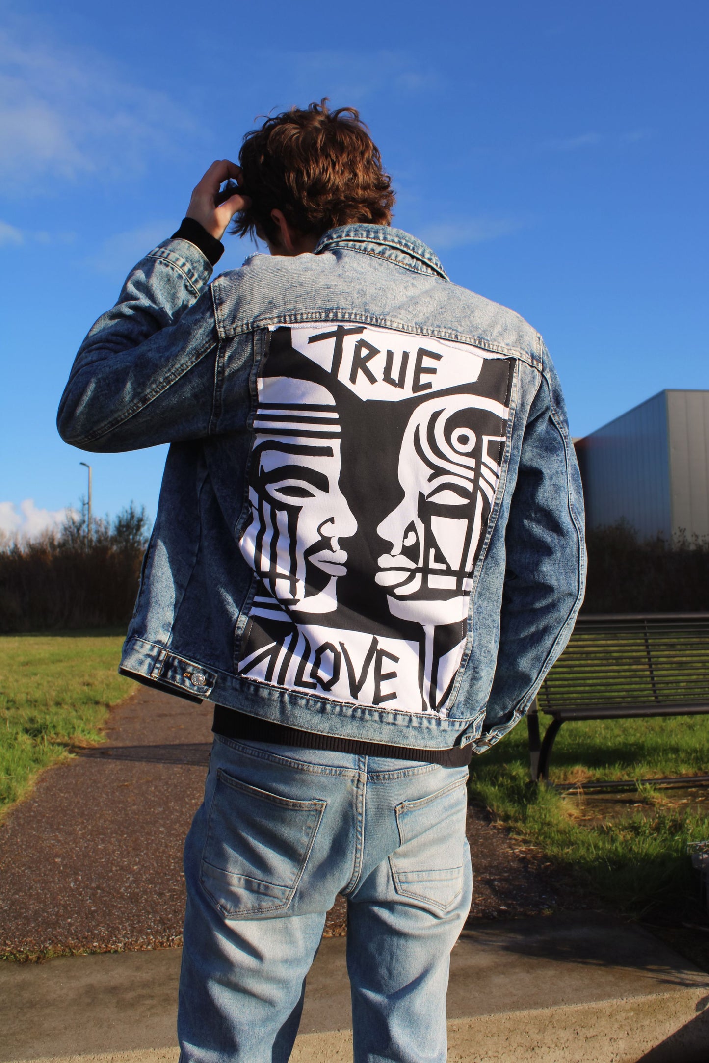 Personalized jean jacket featuring textured fabric and a unique graphic panel for a standout look.