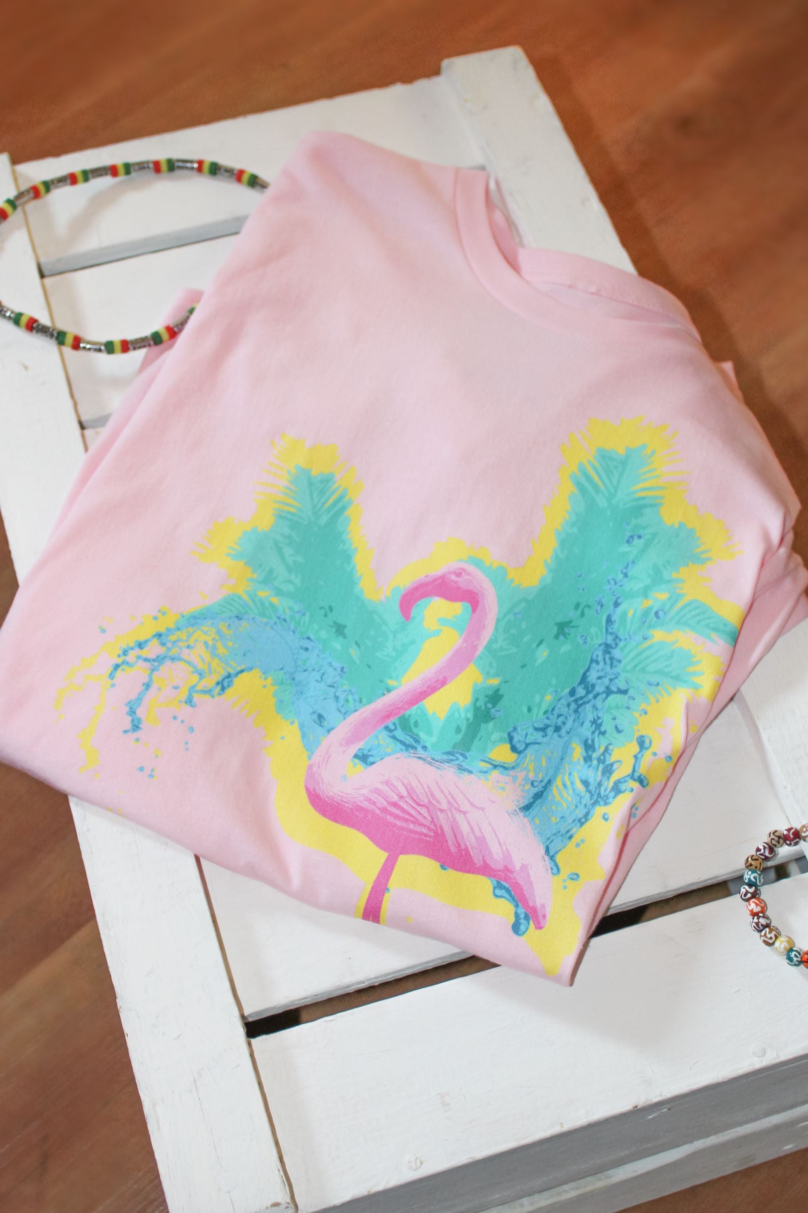 Pink Flamingo T-Shirt: A vibrant pink T-shirt with a tropical flamingo print on the front, perfect for embracing summer vibes