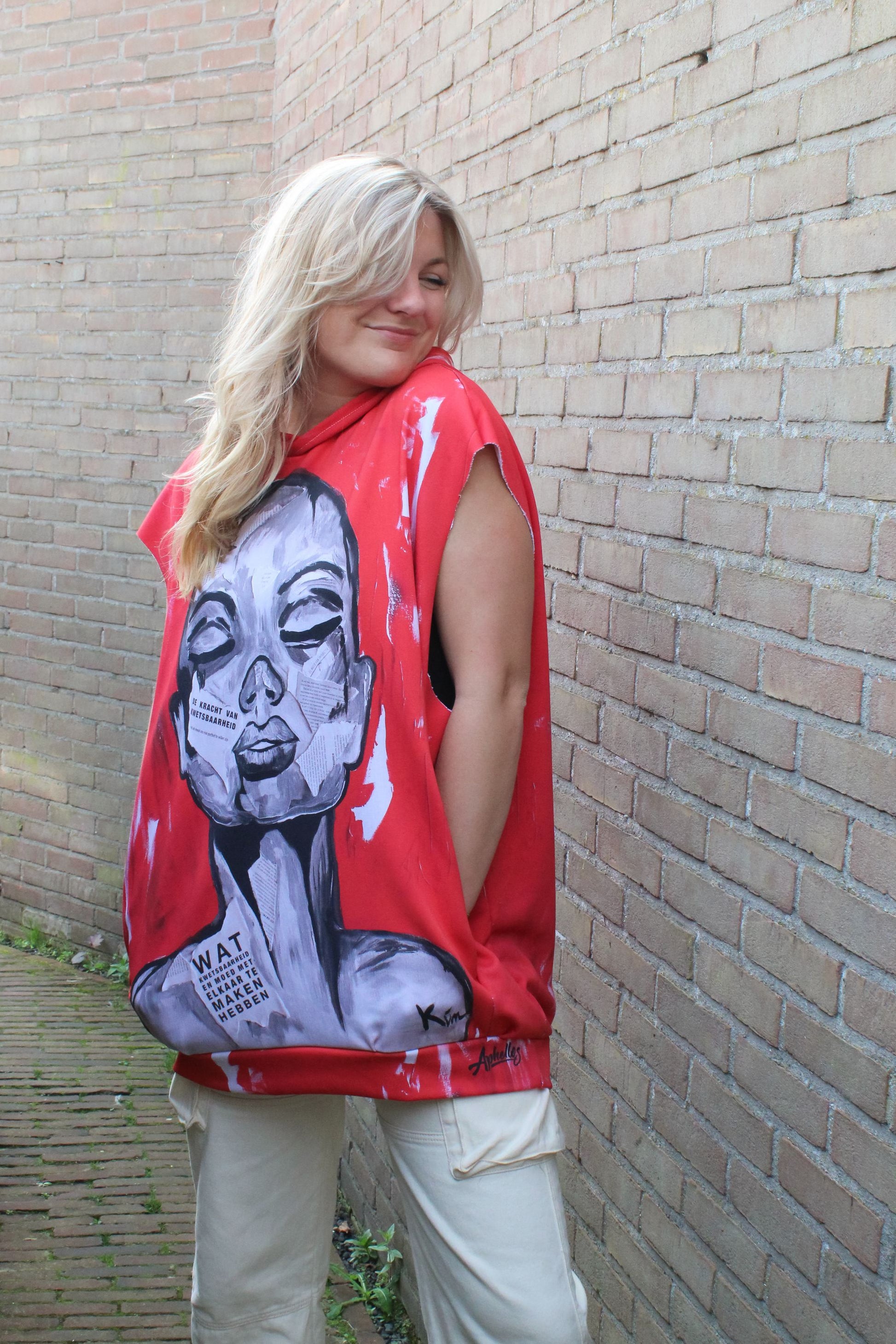 an outside shot of our cool red oversized hoodie in a distinct streetwear style
