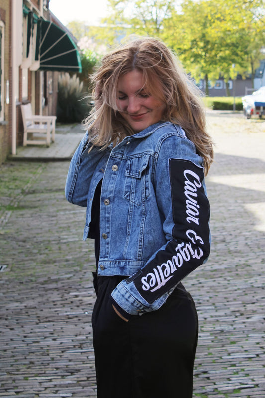 Relaxed fit, cropped denim jacket with long sleeves and artistic black-and-white patterns.