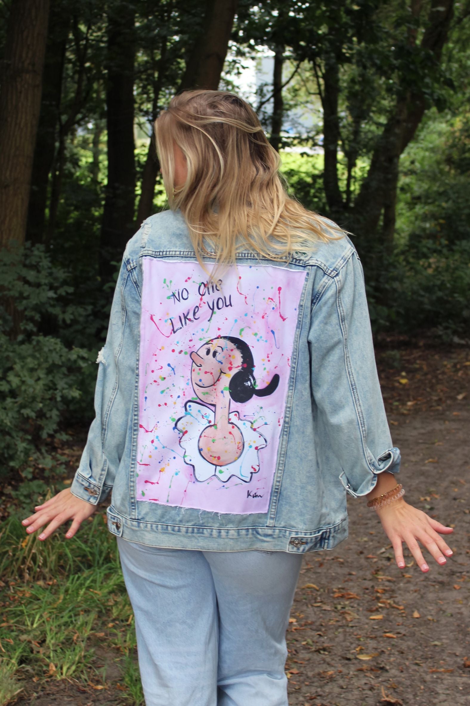 Back panel of light blue denim jacket featuring a vibrant artwork of Sailor Man’s lady, Olive Oyl, with a rough finish.