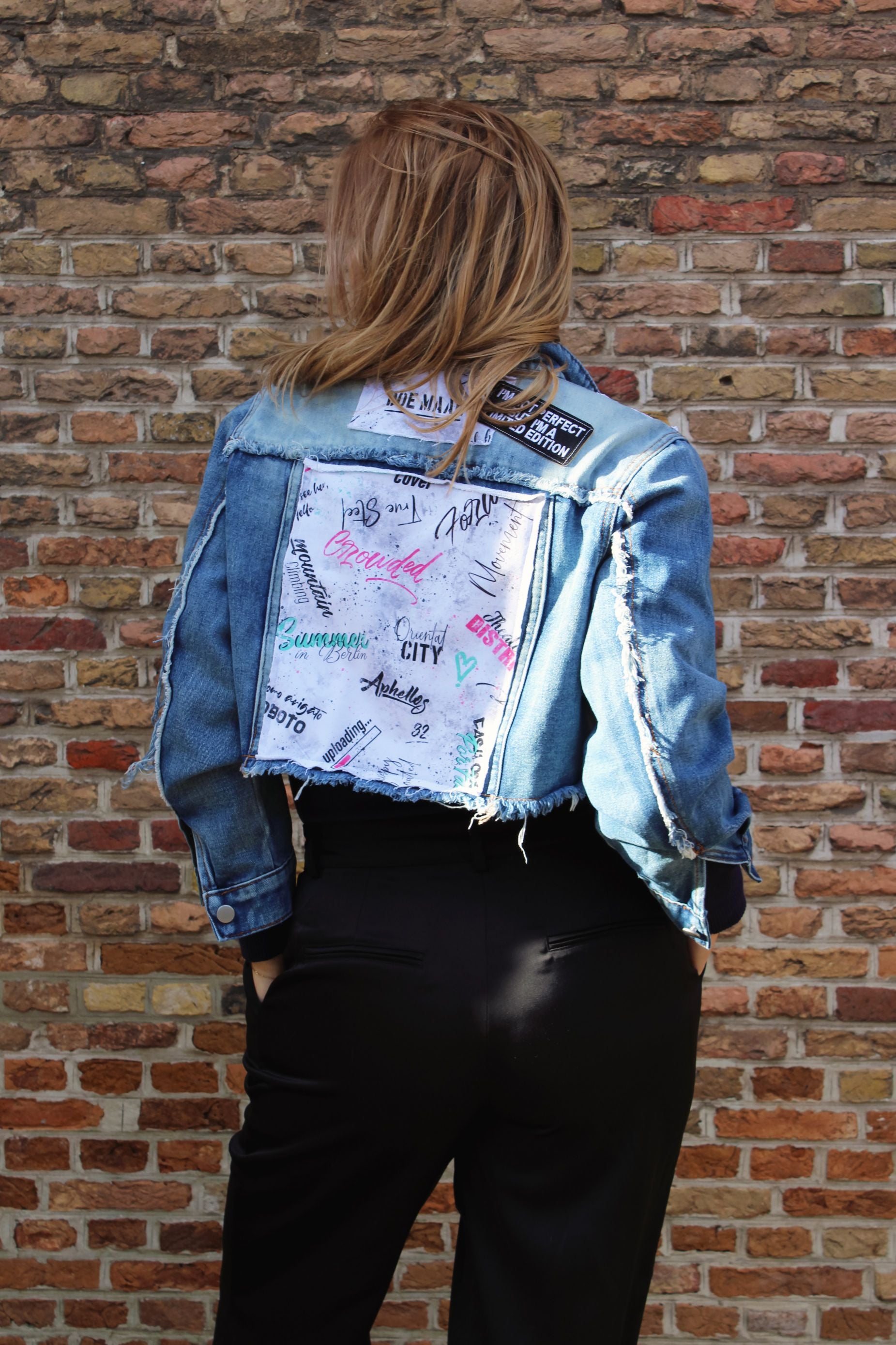 Unique denim jacket with patchwork-style stitched panels and intentional rough finishes for an edgy fashion-forward vibe.