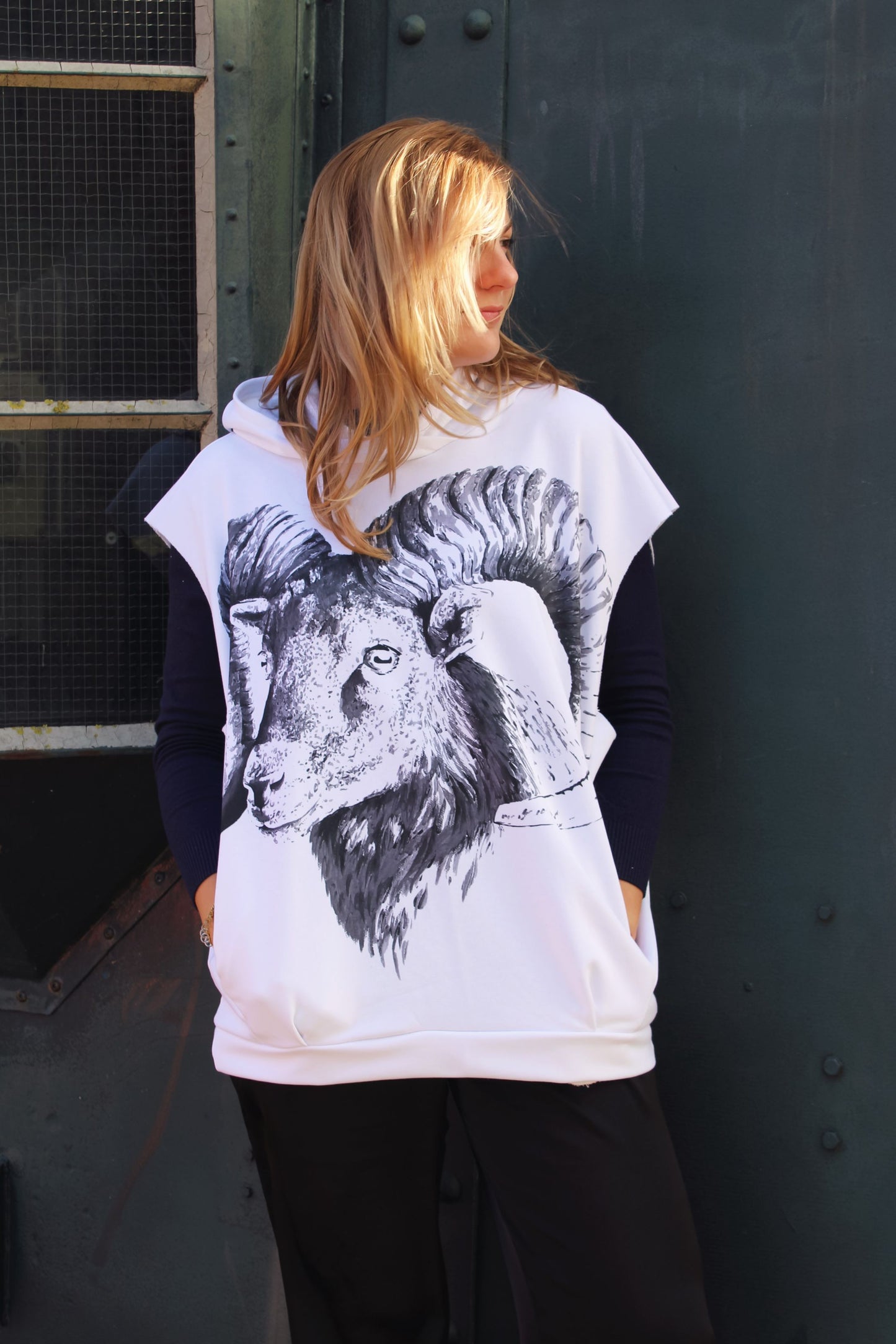 Stylish women’s sleeveless hoodie featuring a striking black-and-white Aries ram graphic.