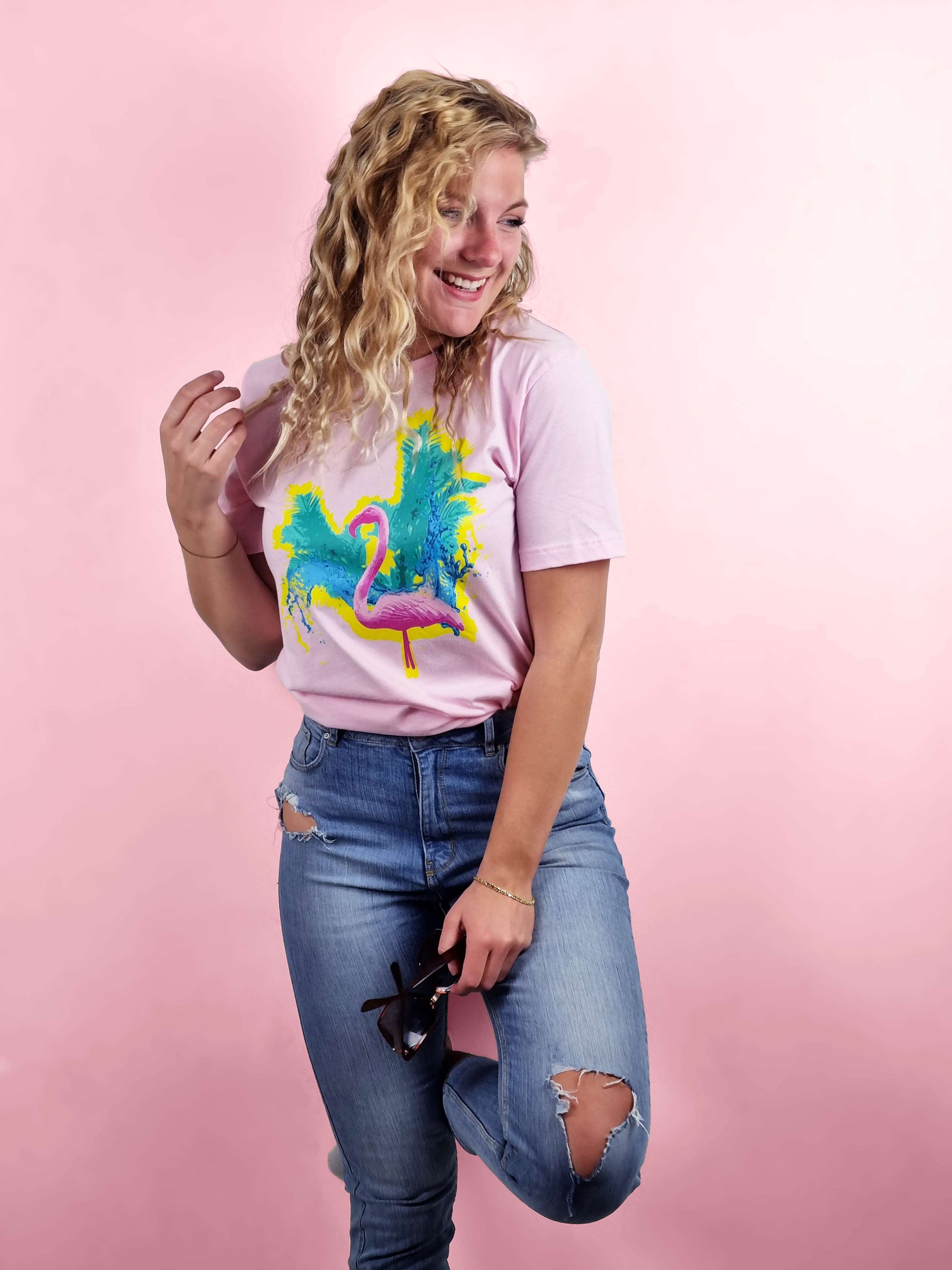 cool and cool looking flamingo print with water and palm tree in the background on this hot pink tee