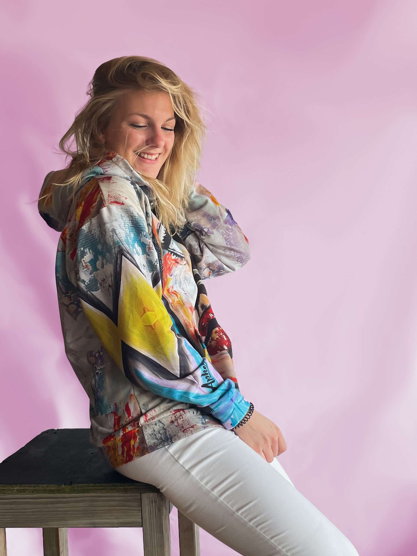 beautiful light blue yellow and beige hoodie on pink background