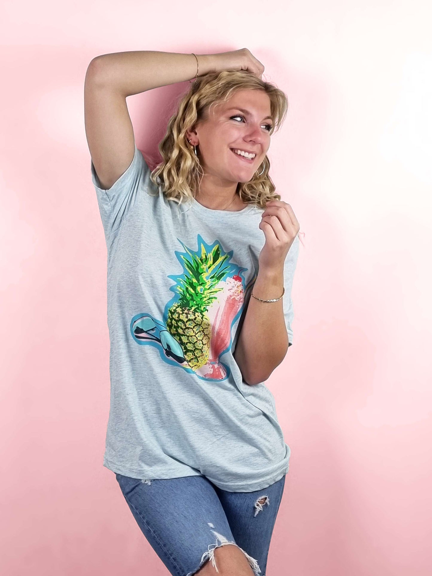 a tropical t-shirt featuring a pineapple, a cocktail and sunglasses. The ultimate bright and colourful summertime t-shirt in light blue